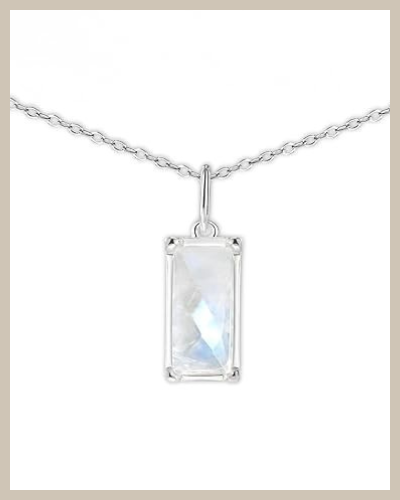 Rectangular faceted rainbow moonstone pendant set in 925 sterling silver on a delicate silver cable chain, minimalist vertical necklace design on white background.