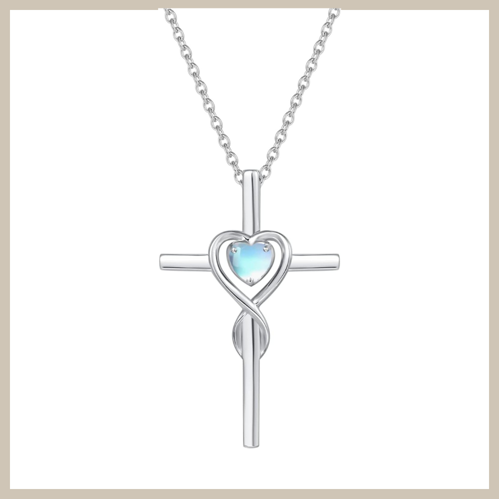 925 sterling silver cross necklace with an infinity-style twist and a small heart-shaped moonstone birthstone set at the center, on a silver cable chain.