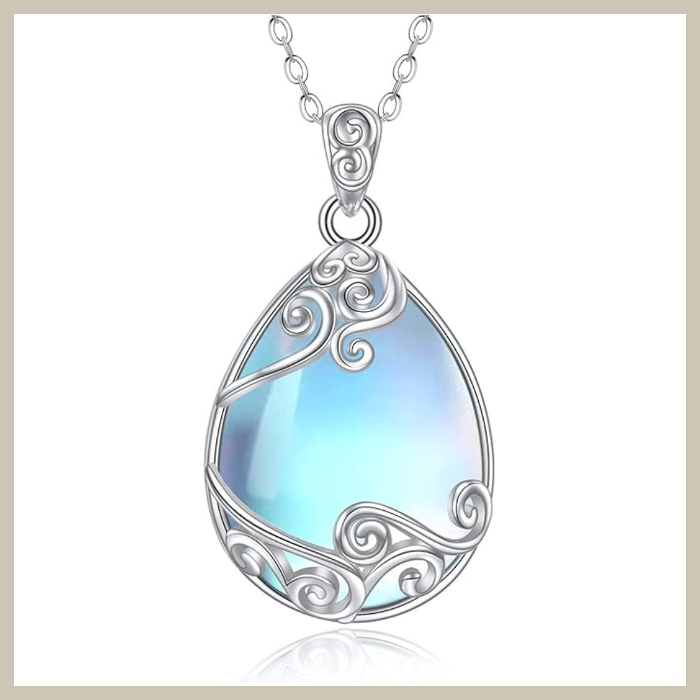 Oval rainbow moonstone pendant set in 925 sterling silver with ornate vintage-style filigree detailing on a silver cable chain.