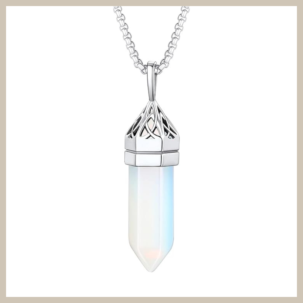 Hexagon-shaped synthetic moonstone crystal pendant with Celtic knot detailing at the top, set in stainless steel on a box chain with lobster clasp.