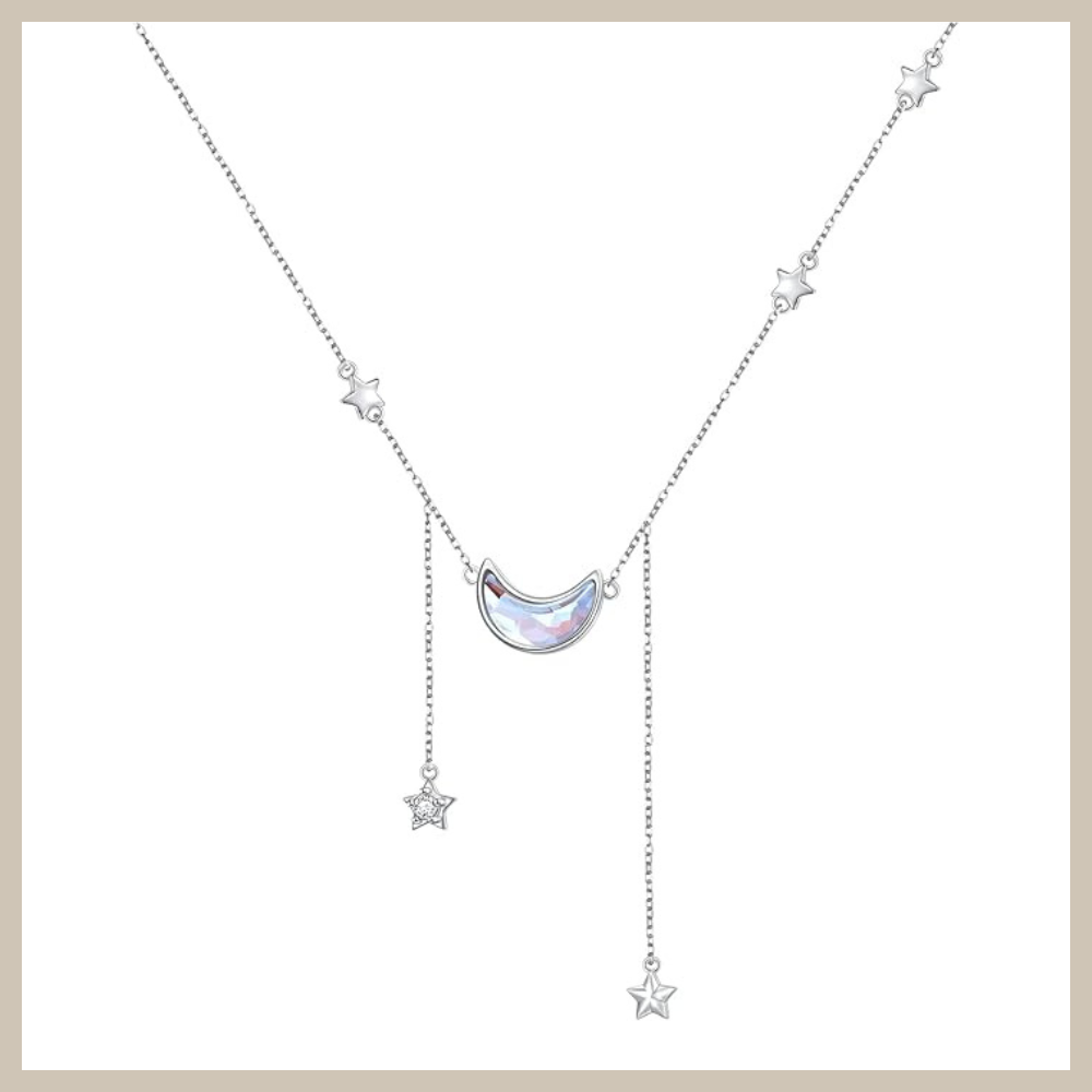 925 sterling silver crescent moon necklace with a created moonstone center and small dangling star accents on a delicate rolo chain.