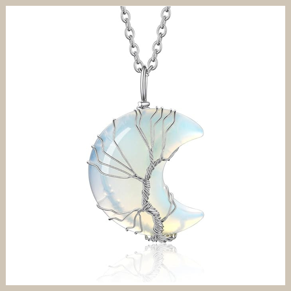 Crescent moon pendant filled with opalescent created moonstone, wrapped in a silver-tone tree of life design on a rolo chain.